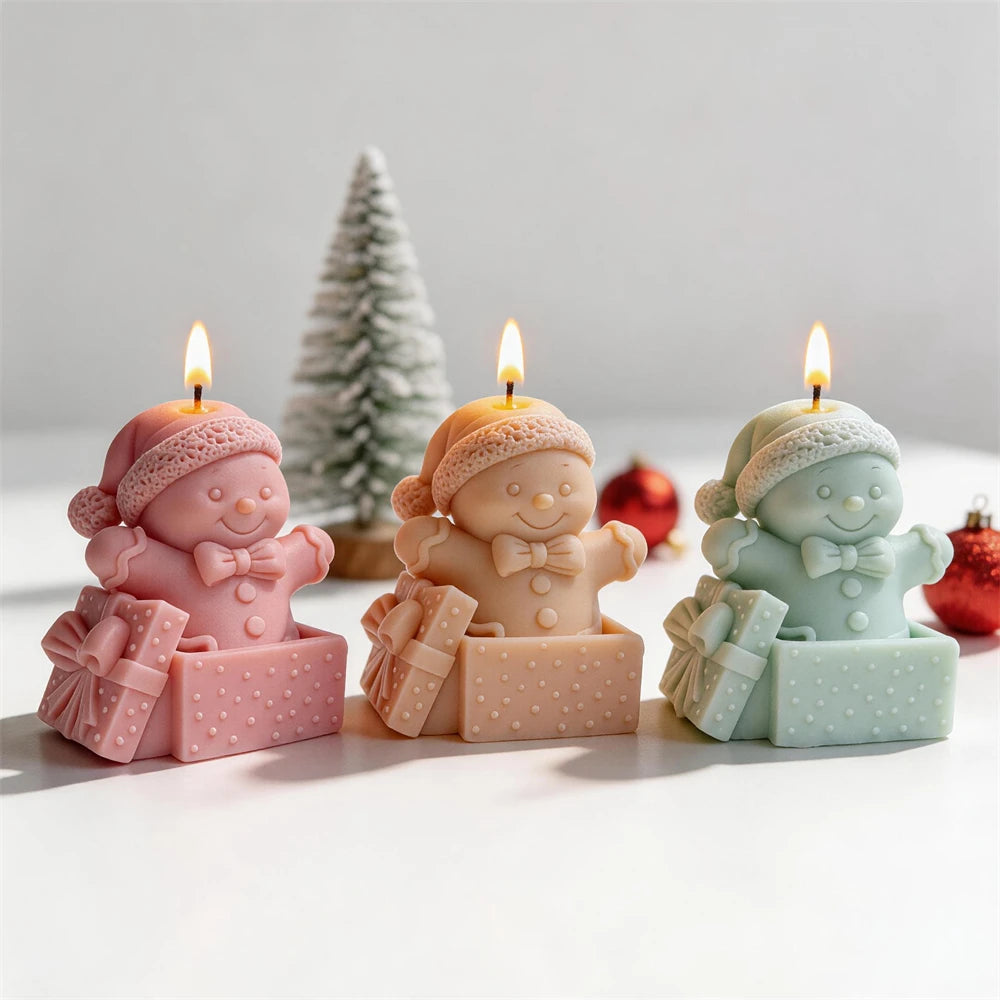 Christmas gingerbread candle sitting inside a decorated present
