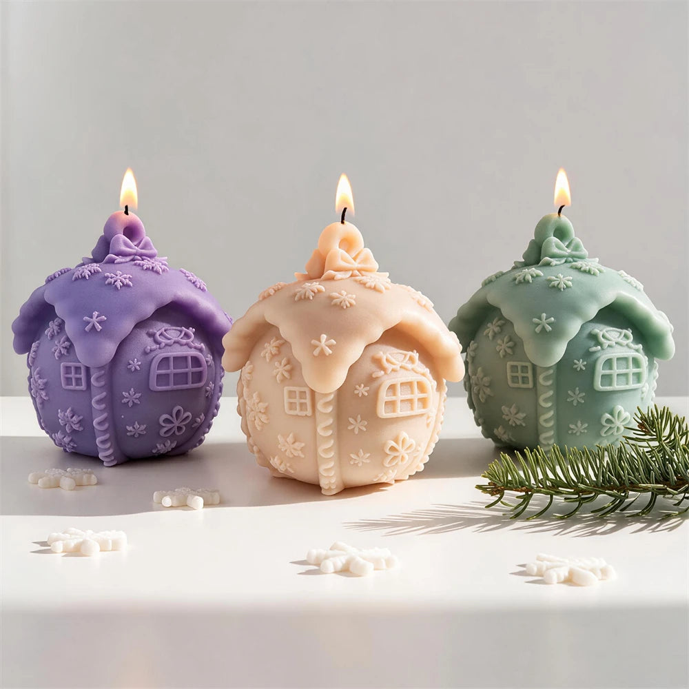 Rounded Christmas cottage candle with frosted roof and snowflakes
