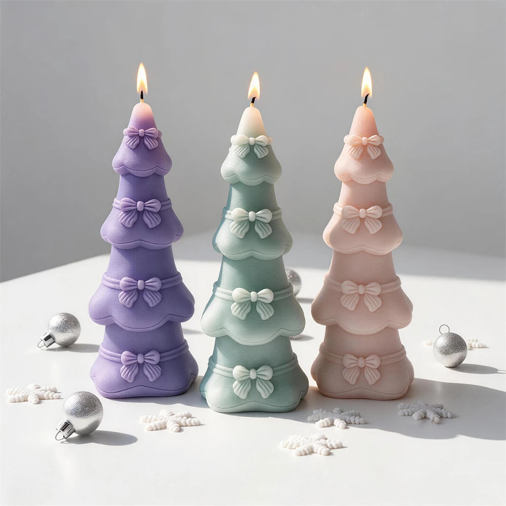 Tall Christmas tree candle decorated with ribbon bows