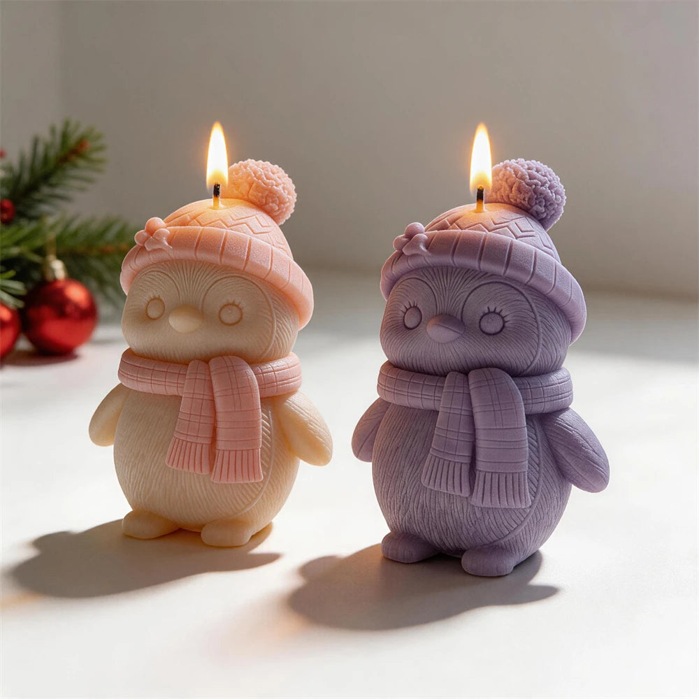 Textured penguin candles displayed with Christmas decorations