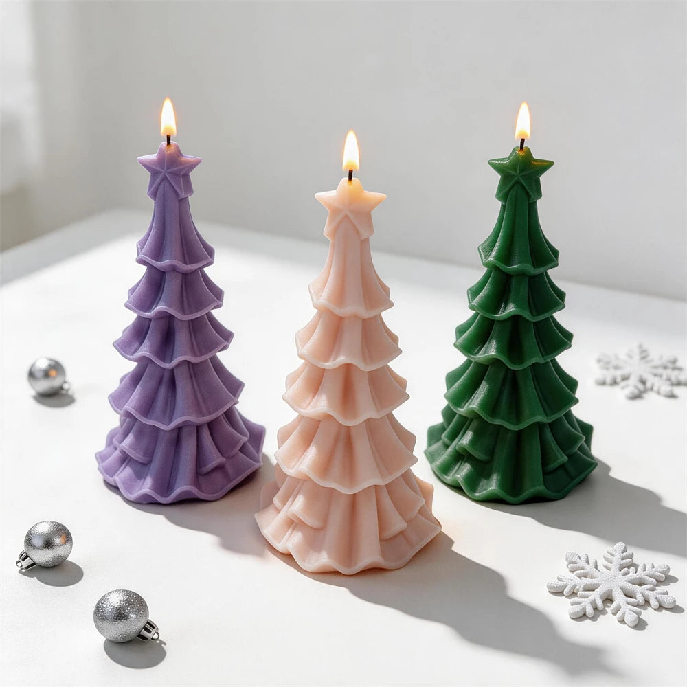 Green, pink and purple Christmas tree candles displayed with festive ornaments