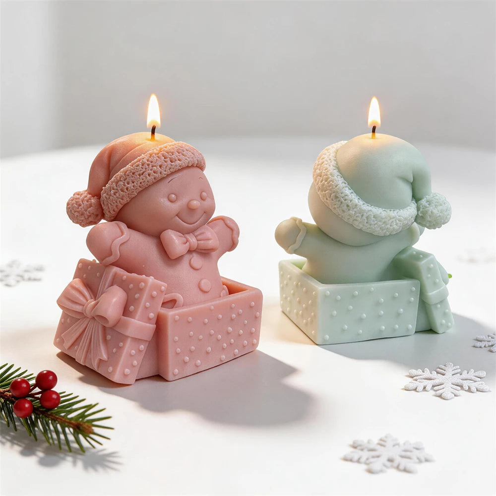 Christmas gingerbread candle sitting inside a decorated present