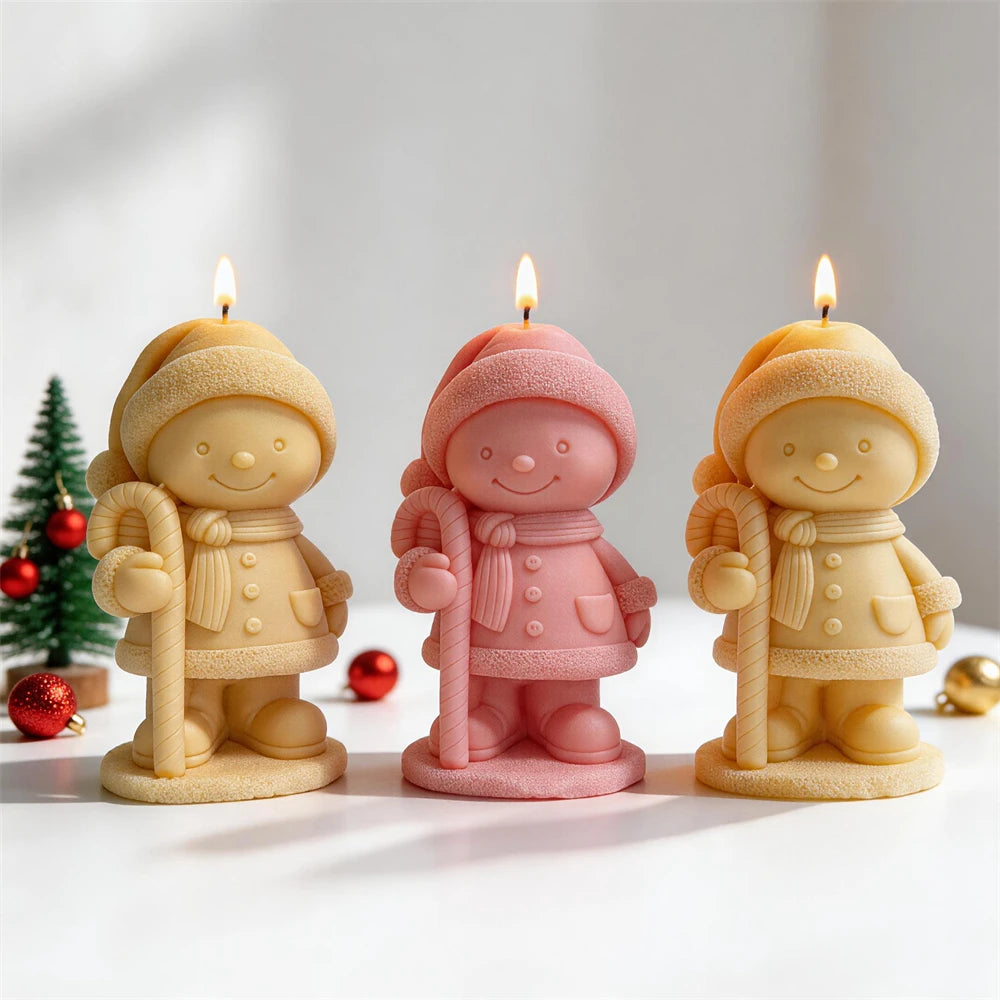 Festive child figurine candles with scarves, coats and winter hats