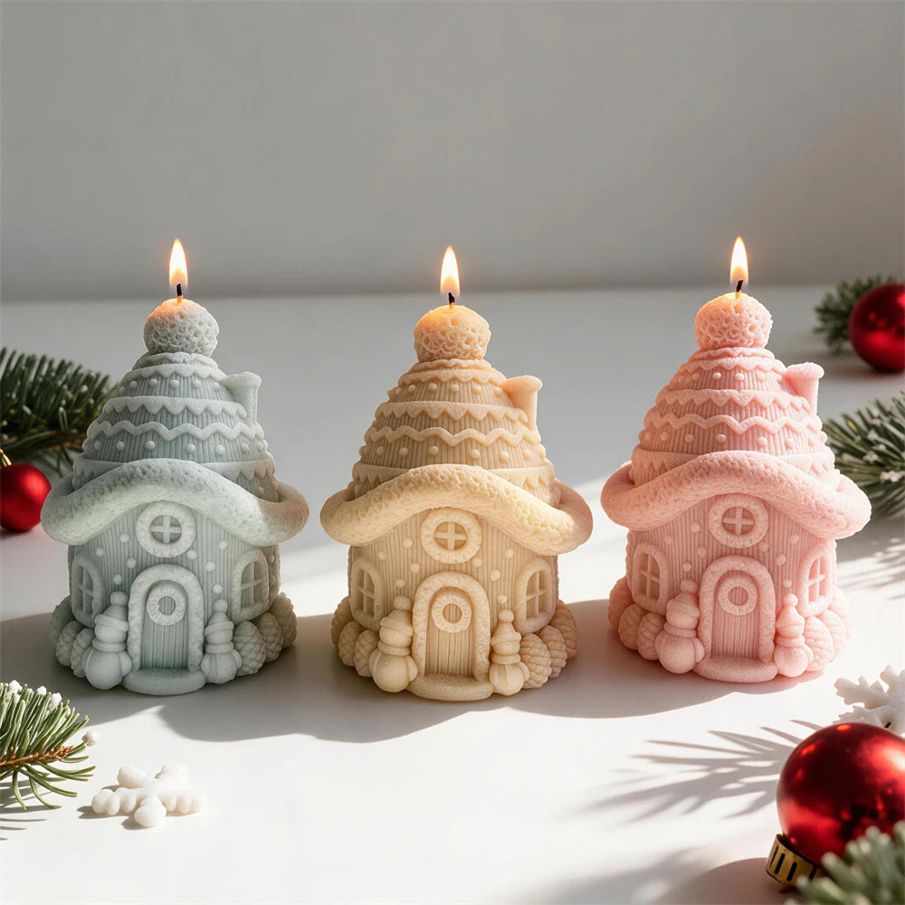 Knitted snow cottage candles with pom-pom roofs and tiny evergreen trees