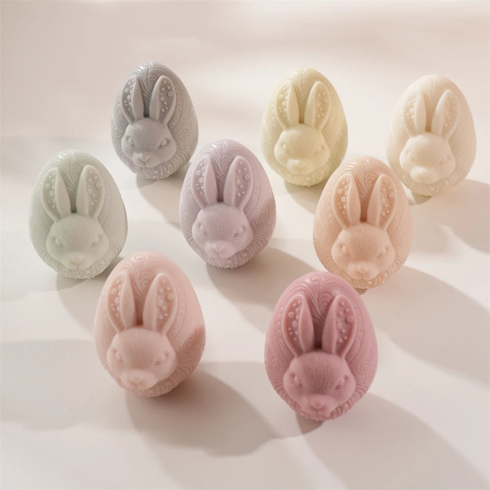 Set of rabbit-shaped soap bars in various colors on a light background