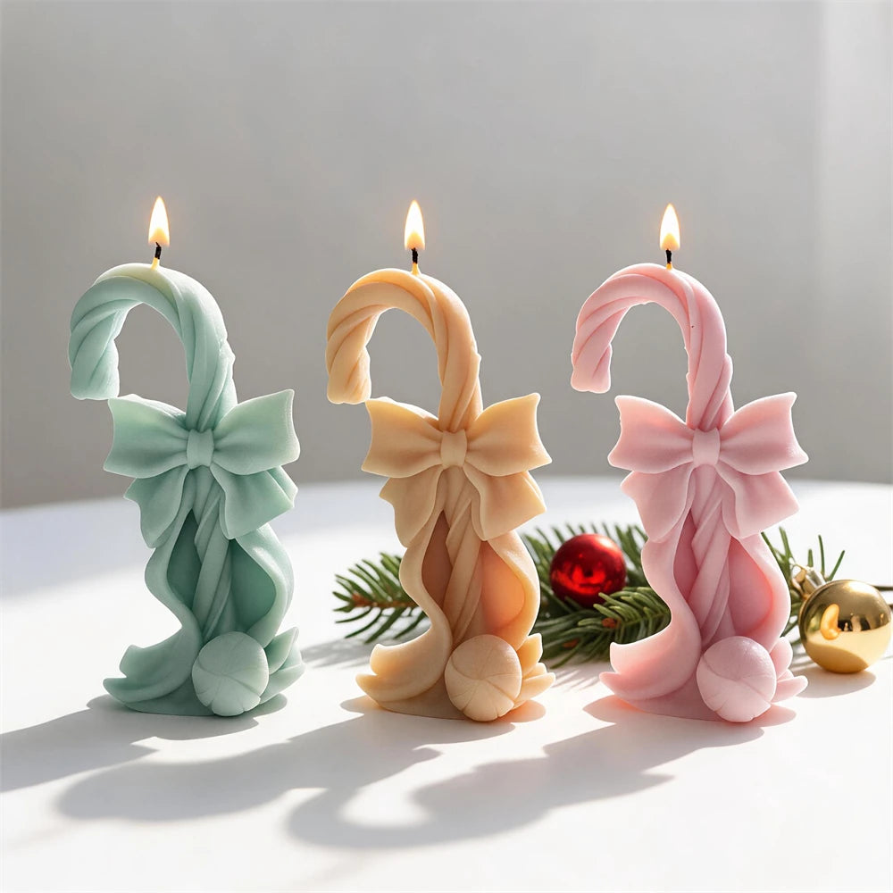 Bow-tied candy cane candles with large layered Christmas ribbon bows