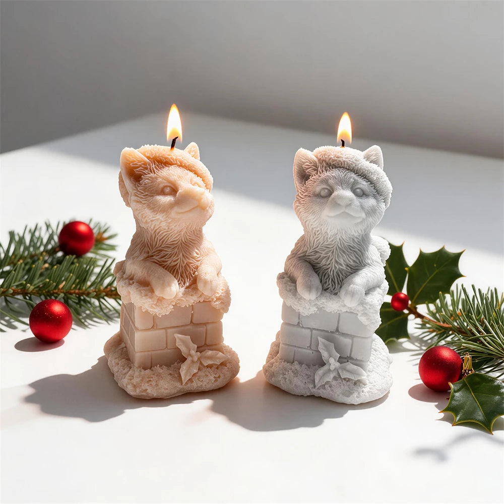 Christmas cat candle peeking from snow-covered chimney with festive hat