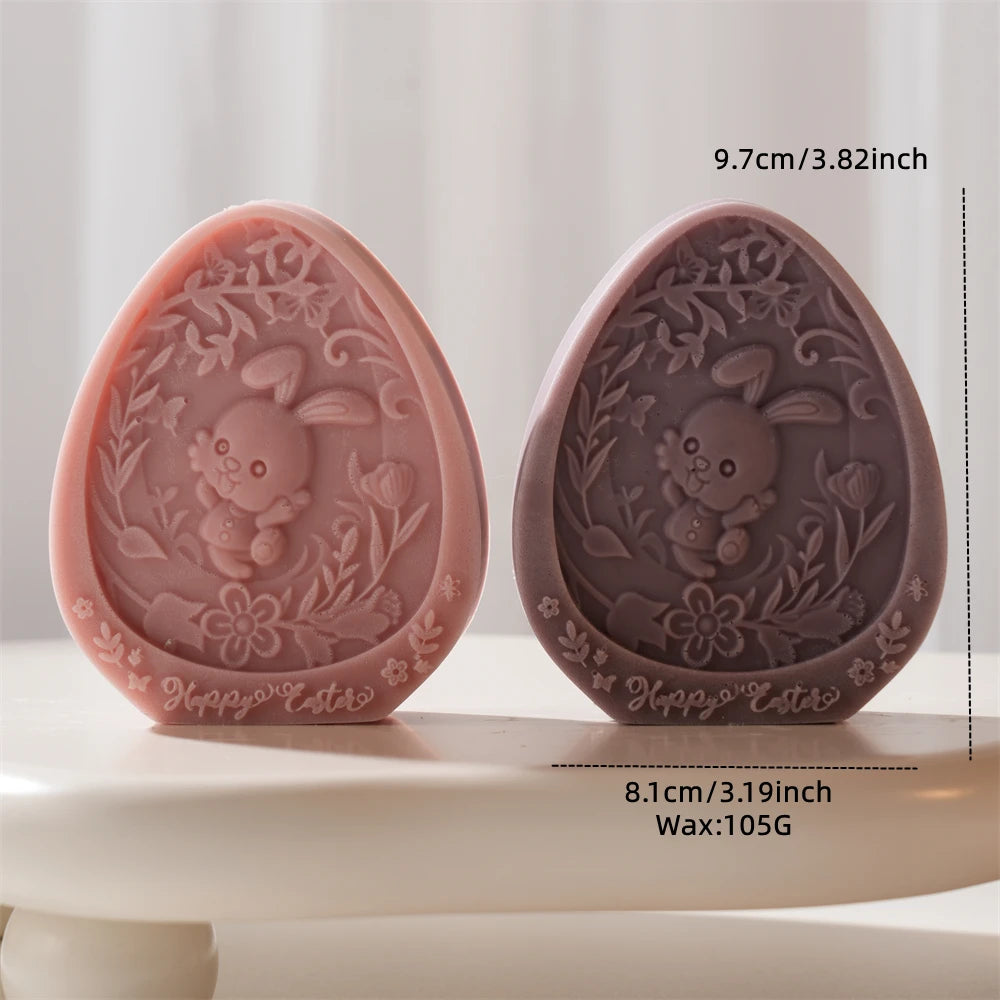 Two Easter-themed soap molds with rabbit and floral design on a white surface.