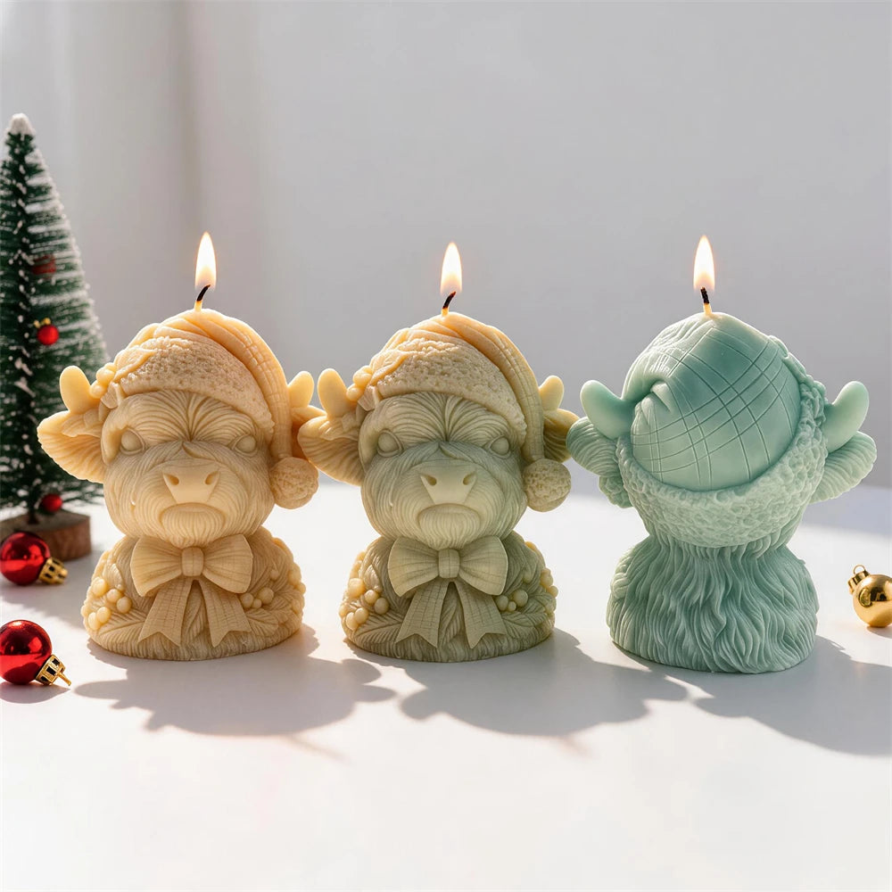 Cream red sage and gold Christmas Highland cow candles for festive décor