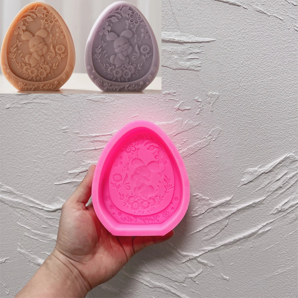 Pink silicone mold with decorative design held by a hand against a light gray background