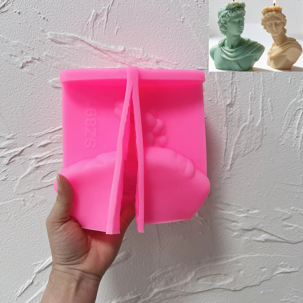 Finished Apollo bust soy candle beside its silicone mold.