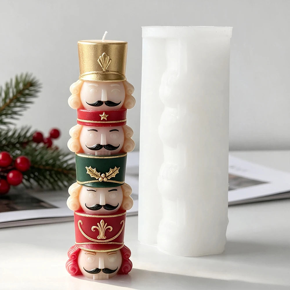 Multicoloured four-soldier nutcracker candle beside the matching upright white silicone casting mold