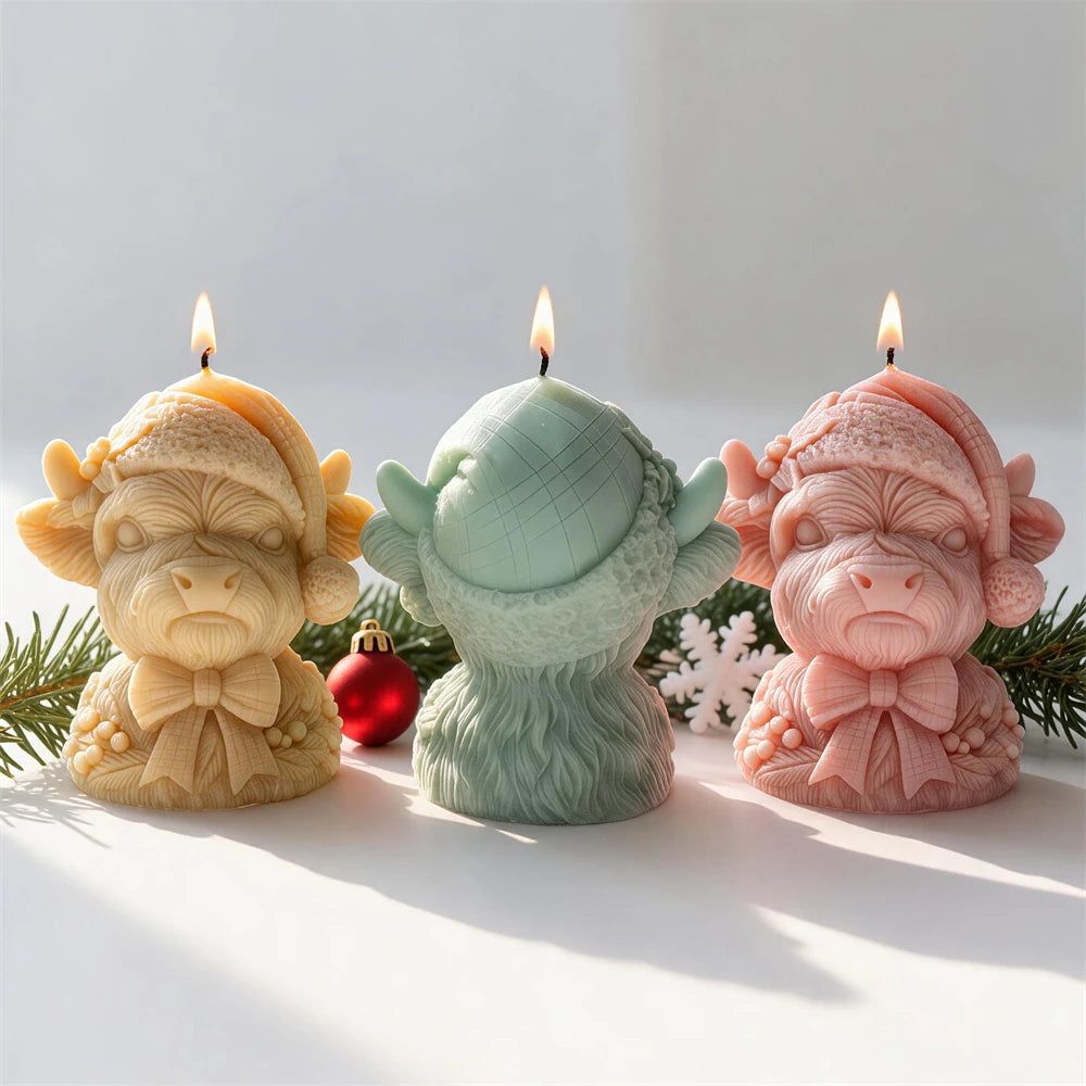 Shaggy Highland cow candle with large bow festive berries and winter hat