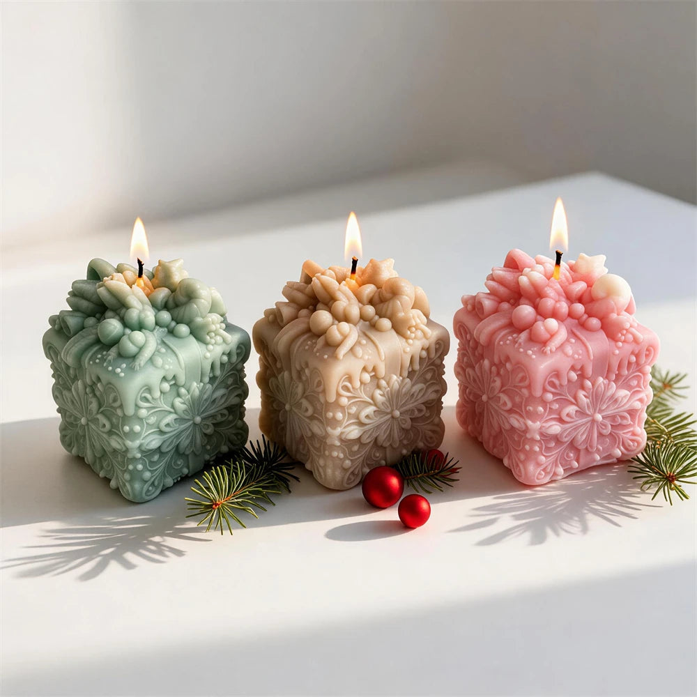 green pink and cream snowflake gift box candles for festive décor