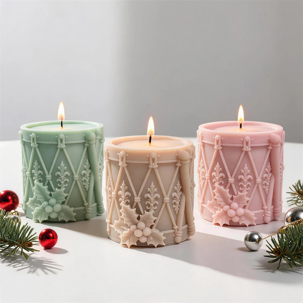 Christmas drum candles with holly leaves berries and decorative rope lacing