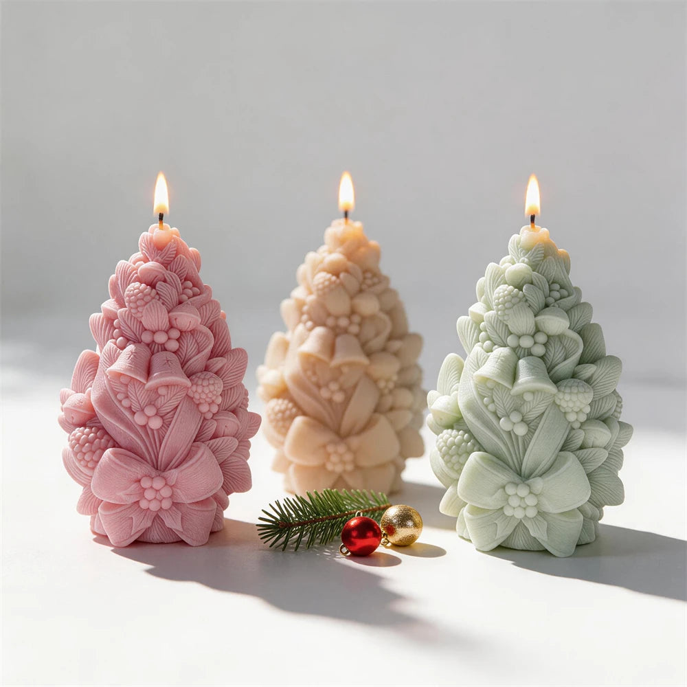 Cream pink and green Christmas tree candles with pinecone and bell details