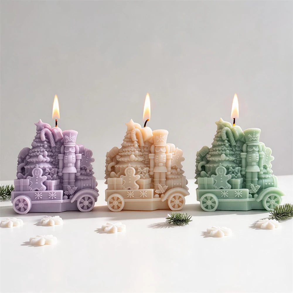 Toy locomotive candle with Christmas tree candy canes gifts and gingerbread men