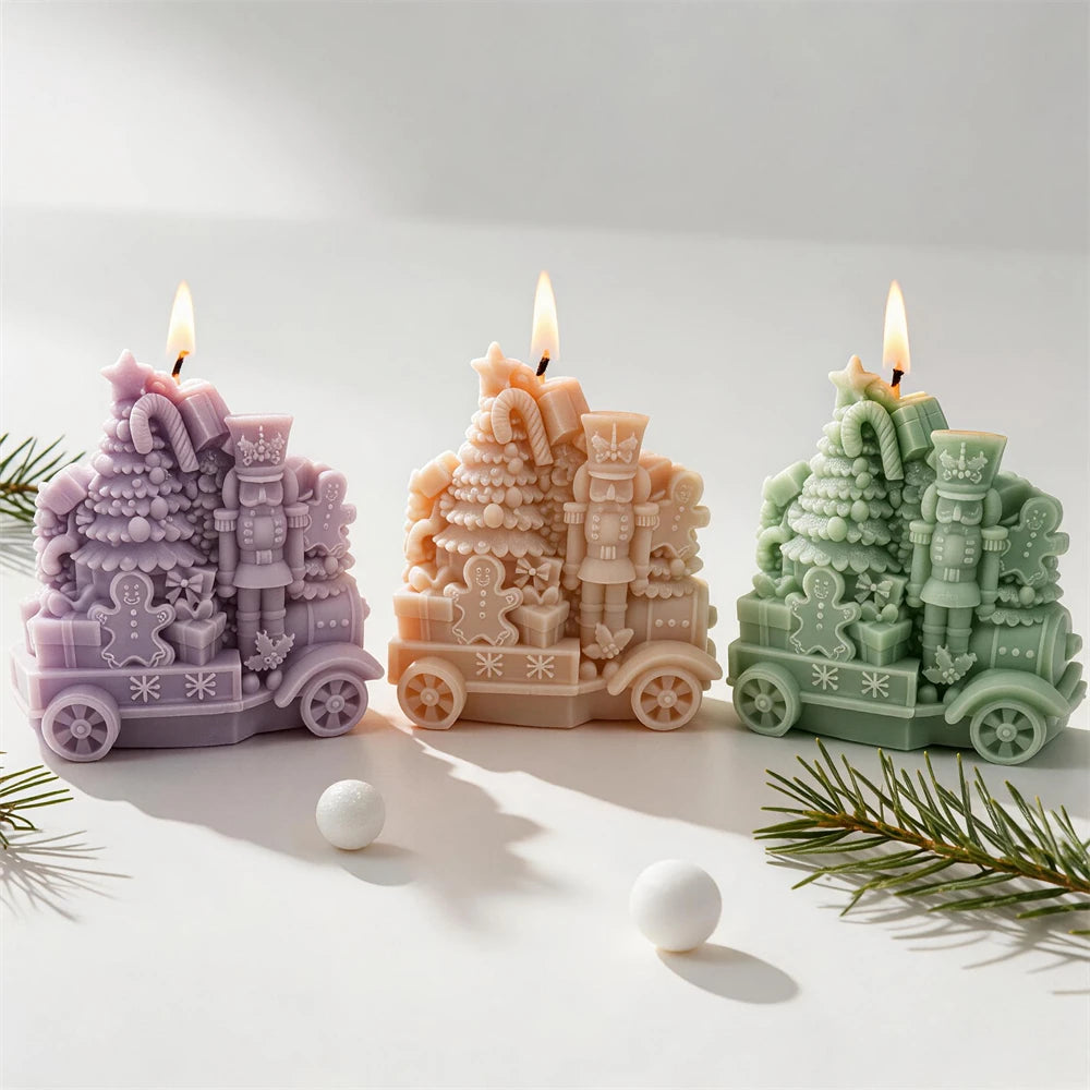 Toy locomotive candle with Christmas tree candy canes gifts and gingerbread men