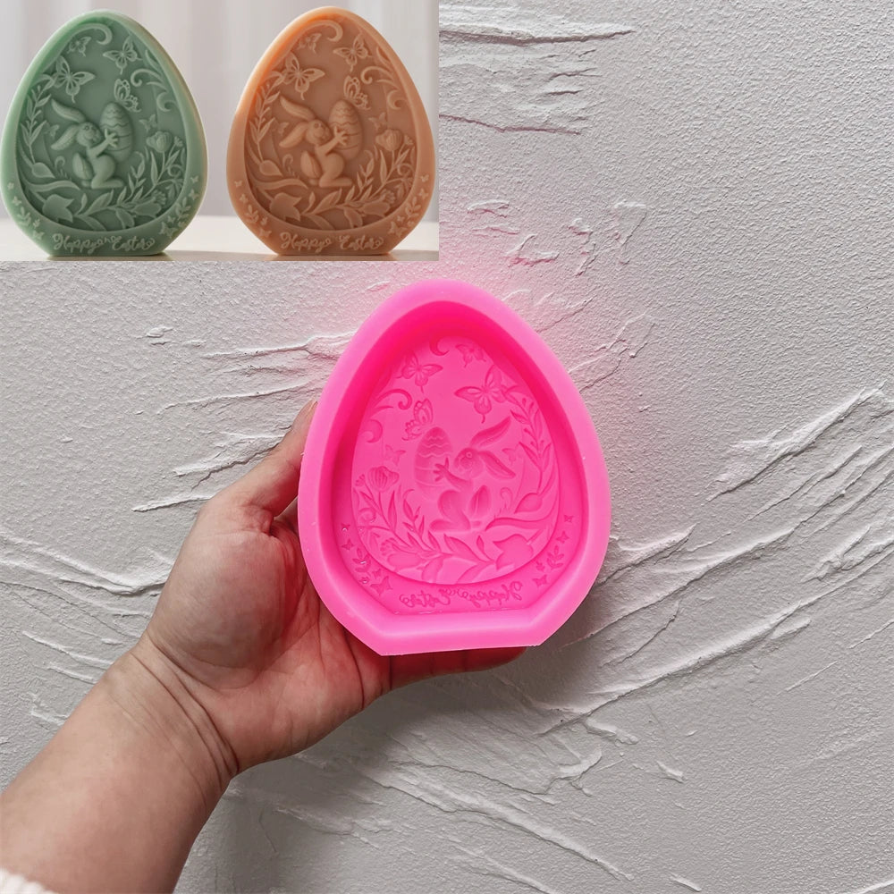 Pink silicone mold with decorative design held by a hand against a light gray background.