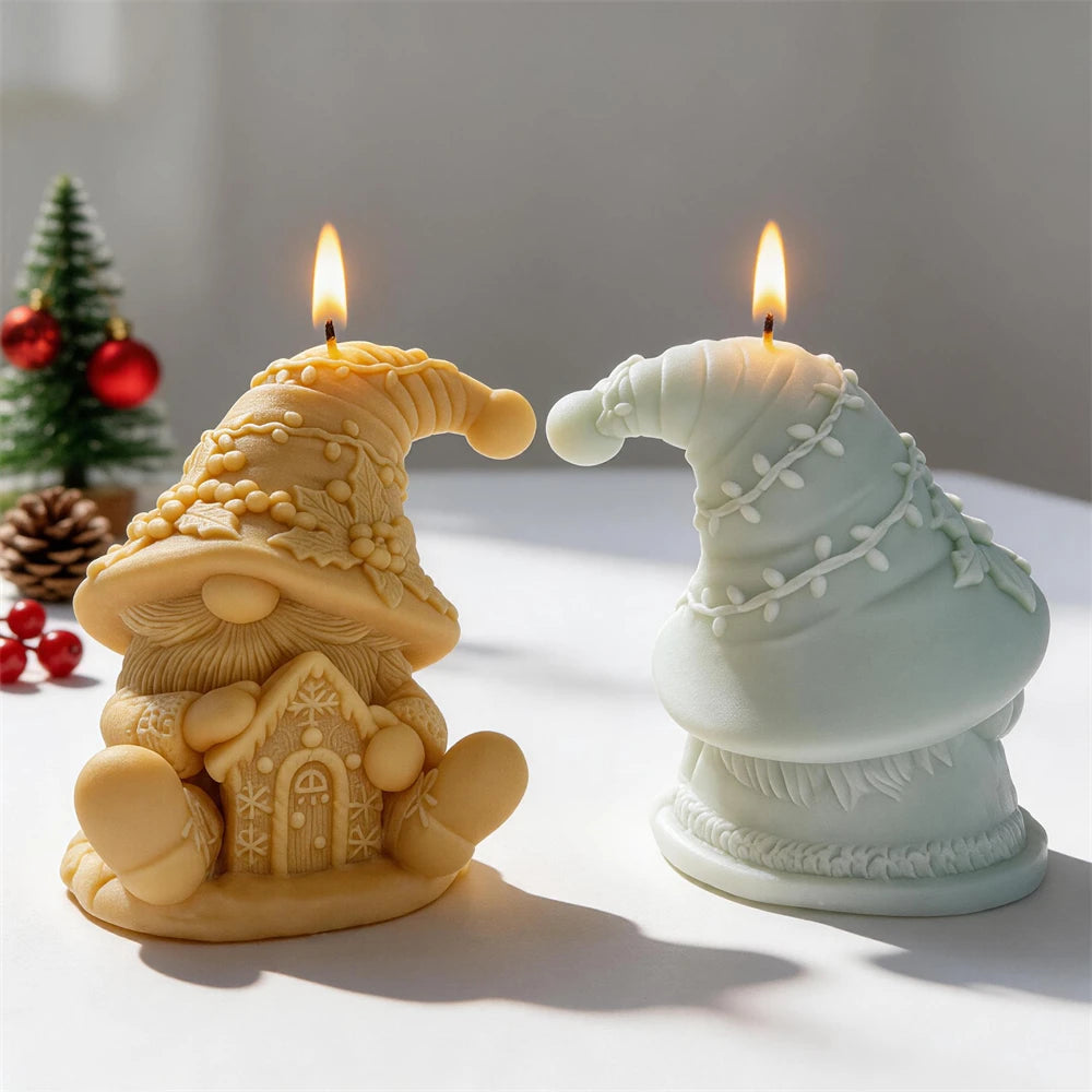 Christmas gnome candles holding a miniature gingerbread house