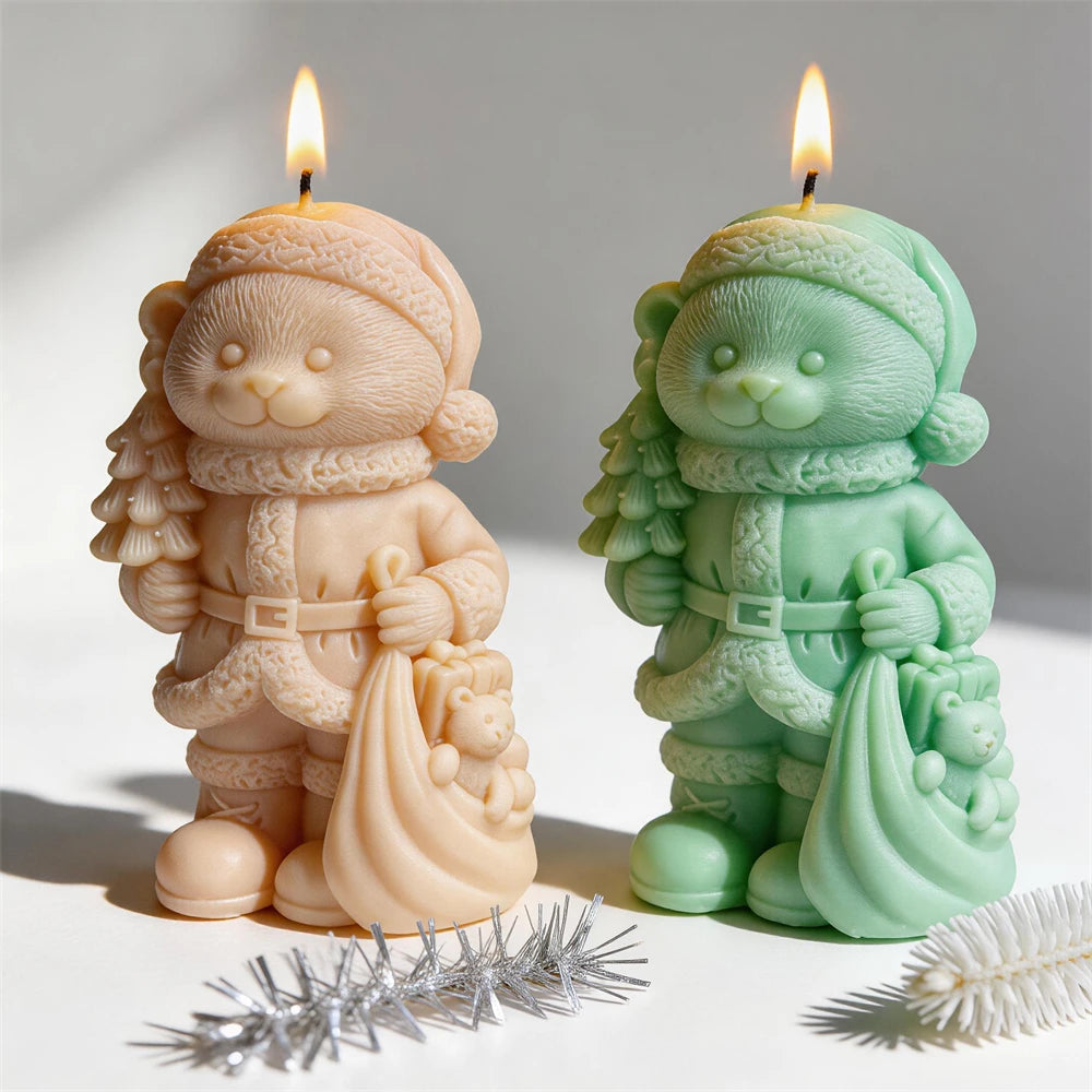 Christmas bear candles carrying a small tree and gift sack