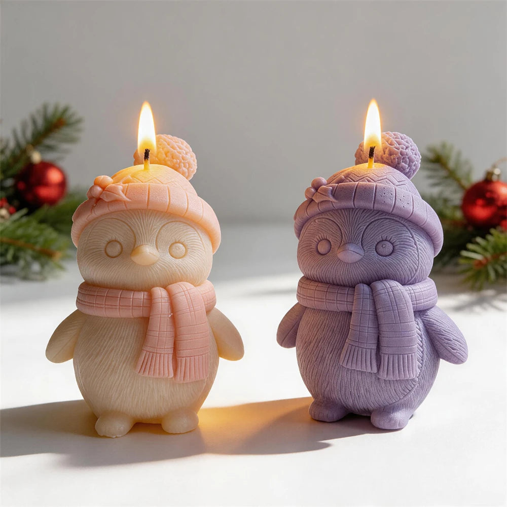 Christmas penguin candle wearing a pom-pom hat and scarf