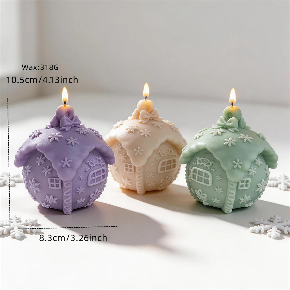 Snowy cottage candle measuring 10.5 centimetres tall