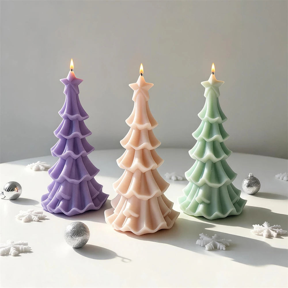 Star-topped Christmas tree candles with flowing layered branches