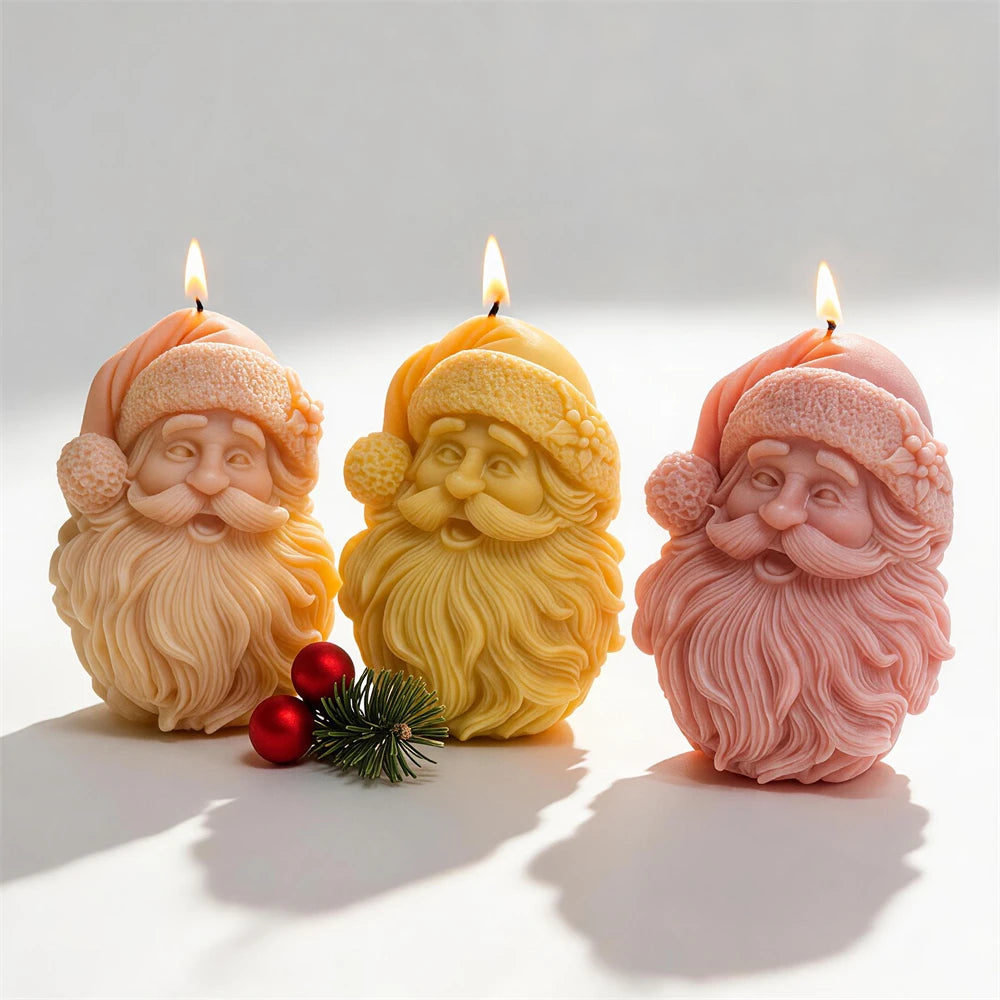 Bearded Santa face candles in cream, yellow and pink wax