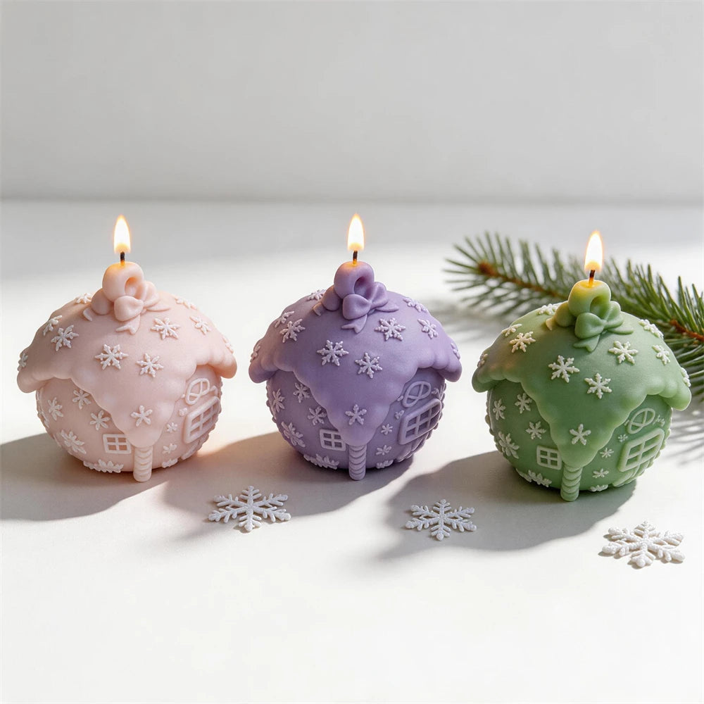 Rounded Christmas cottage candle with frosted roof and snowflakes