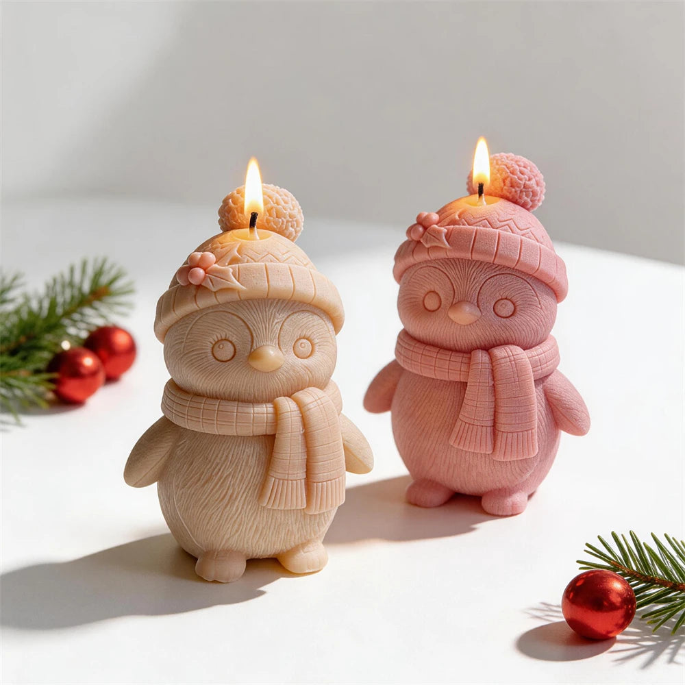 Christmas penguin candle wearing a pom-pom hat and scarf