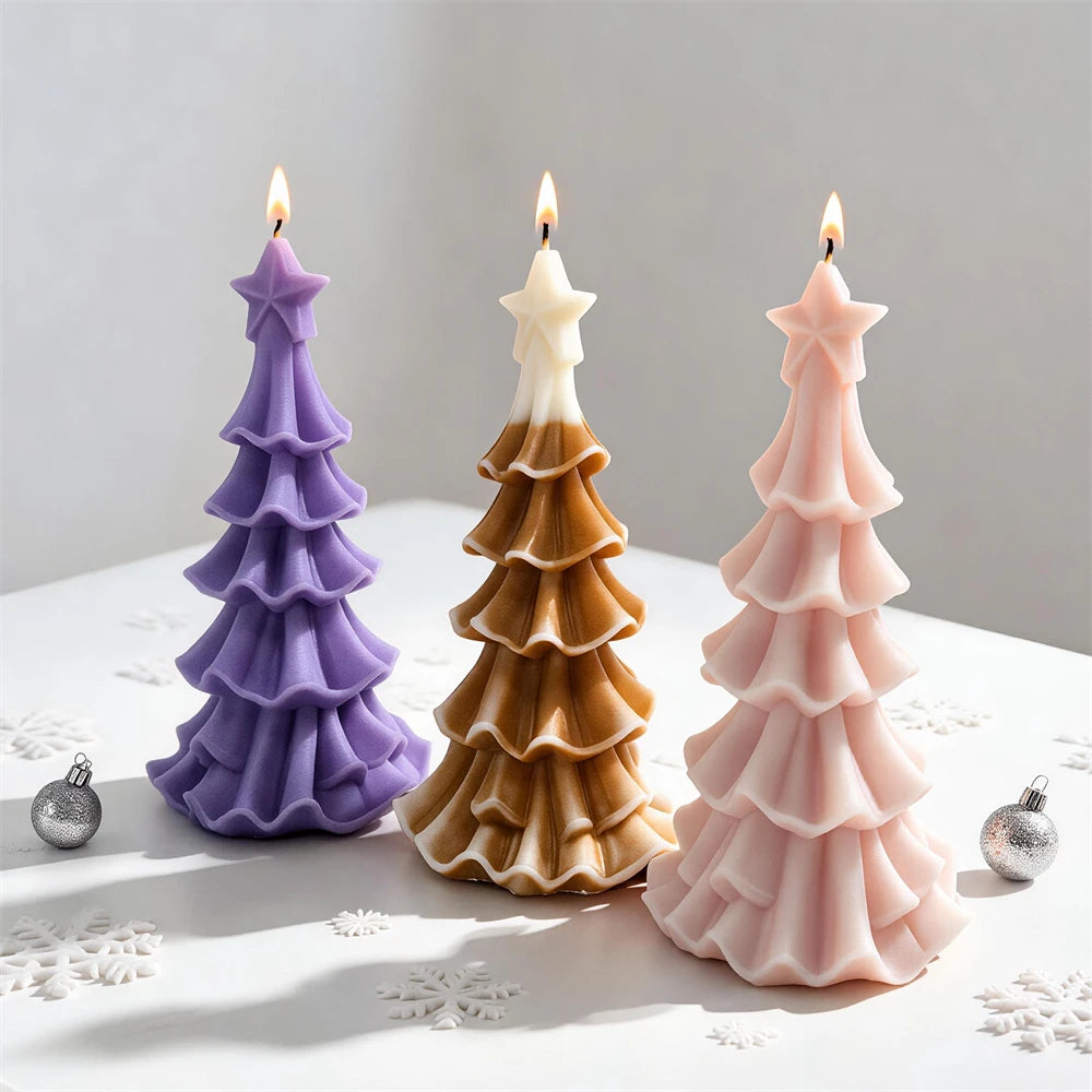 Star-topped Christmas tree candles with flowing layered branches