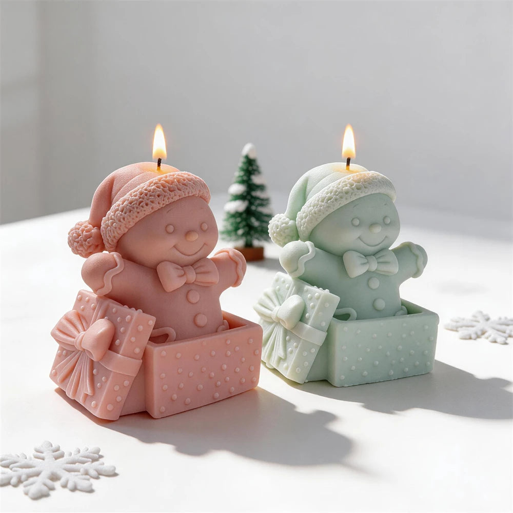 Festive gingerbread character candles with Santa hats and gift bows