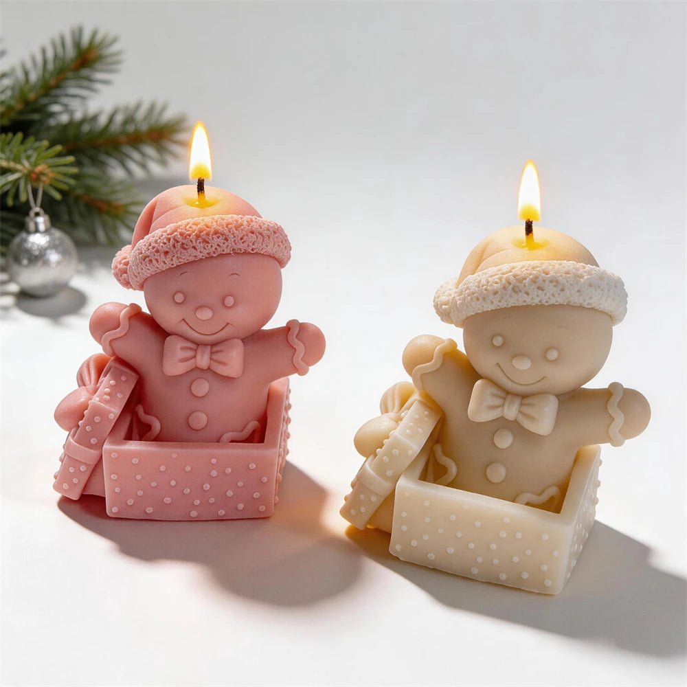 Festive gingerbread character candles with Santa hats and gift bows