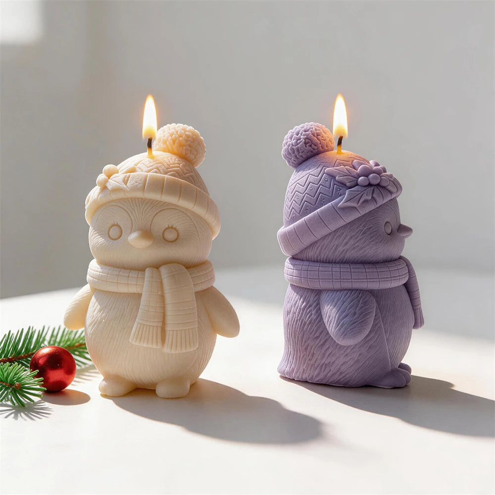 Textured penguin candles displayed with Christmas decorations
