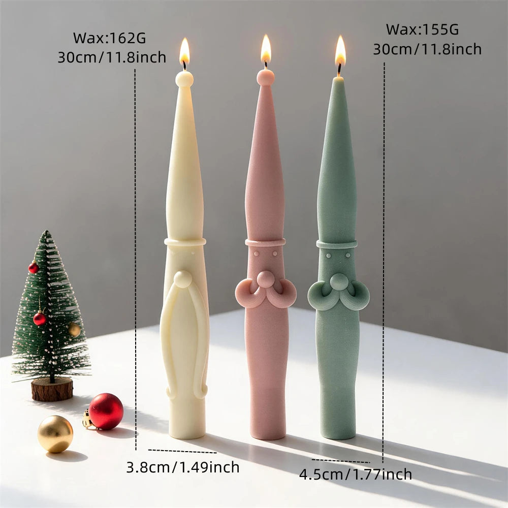 Scandinavian Santa candles displayed beside Christmas decorations