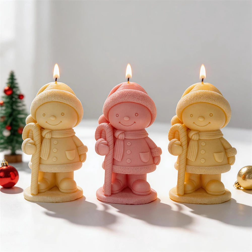 Festive child figurine candles with scarves, coats and winter hats