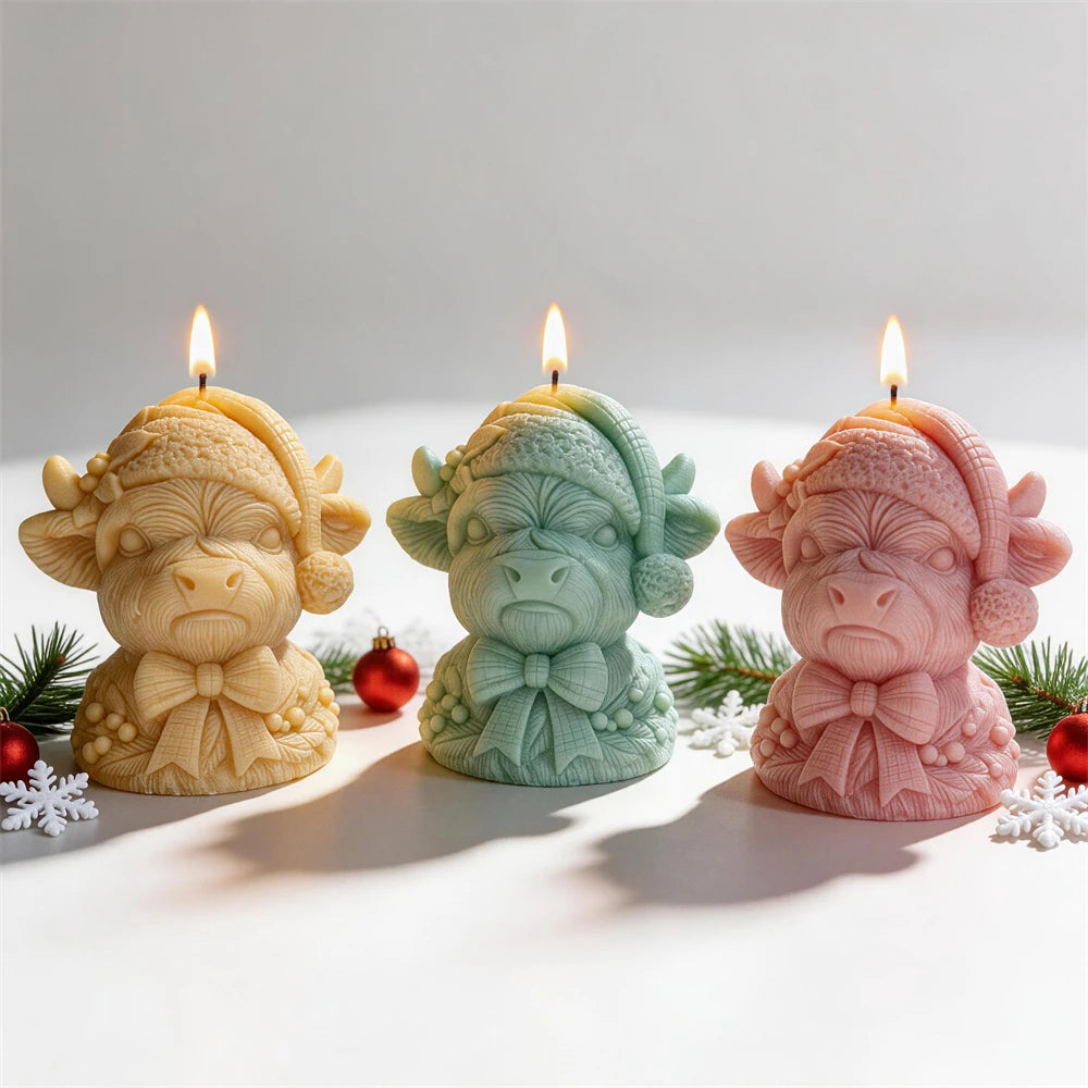 Christmas Highland cow candles wearing knitted Santa hats and ribbon bows
