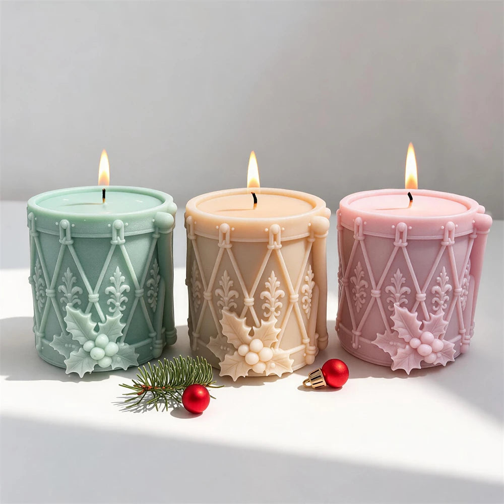 Festive toy drum candle with holly berry cluster and ornamental patterns