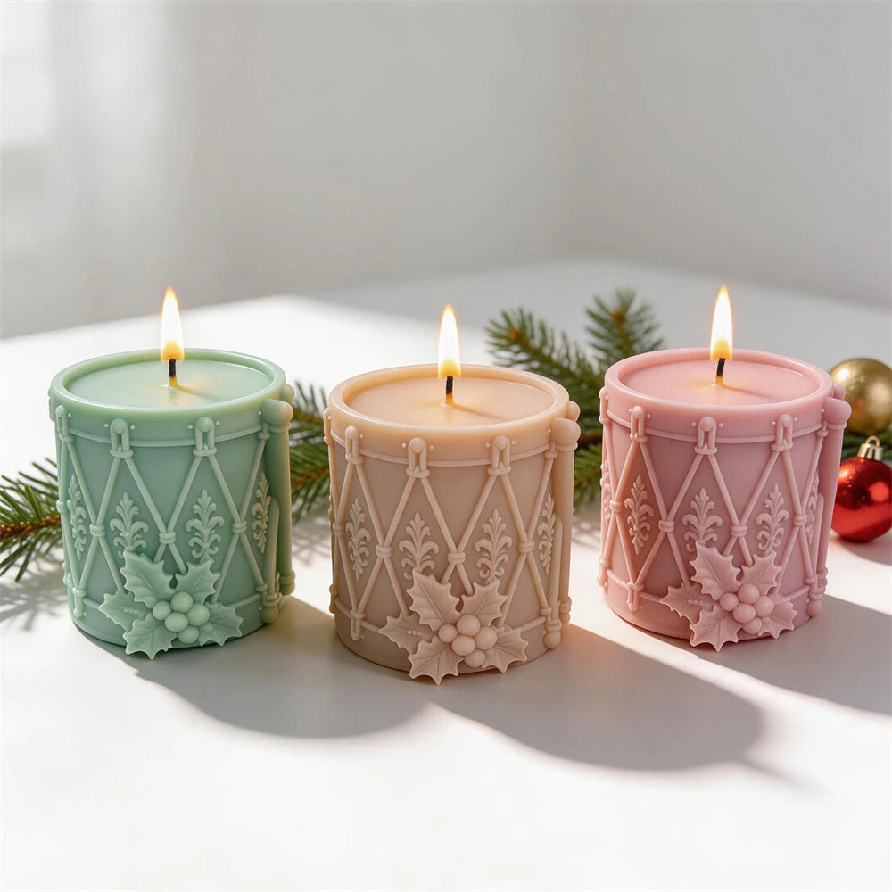Festive toy drum candle with holly berry cluster and ornamental patterns