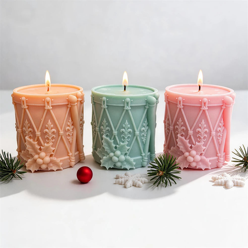 Festive toy drum candle with holly berry cluster and ornamental patterns