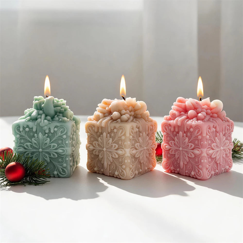 green pink and cream snowflake gift box candles for festive décor