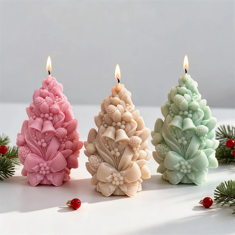 Cream pink and green Christmas tree candles with pinecone and bell details