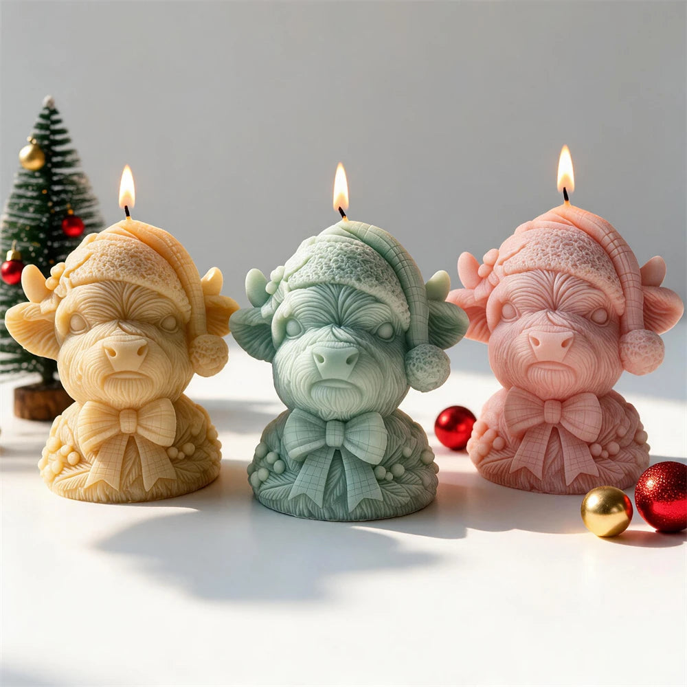 Christmas Highland cow candles wearing knitted Santa hats and ribbon bows