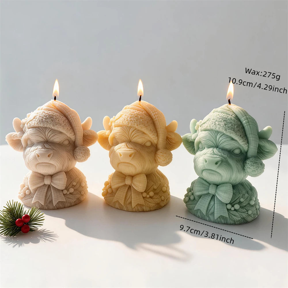 Christmas Highland cow candle measuring 10.9 centimetres tall