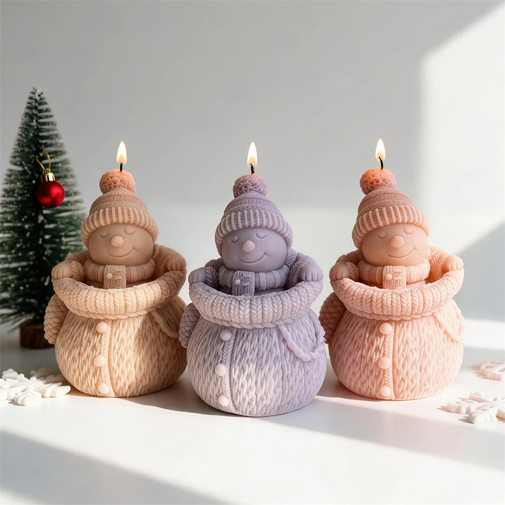 Knitted snowman candles with pom-pom hats and chunky winter scarves
