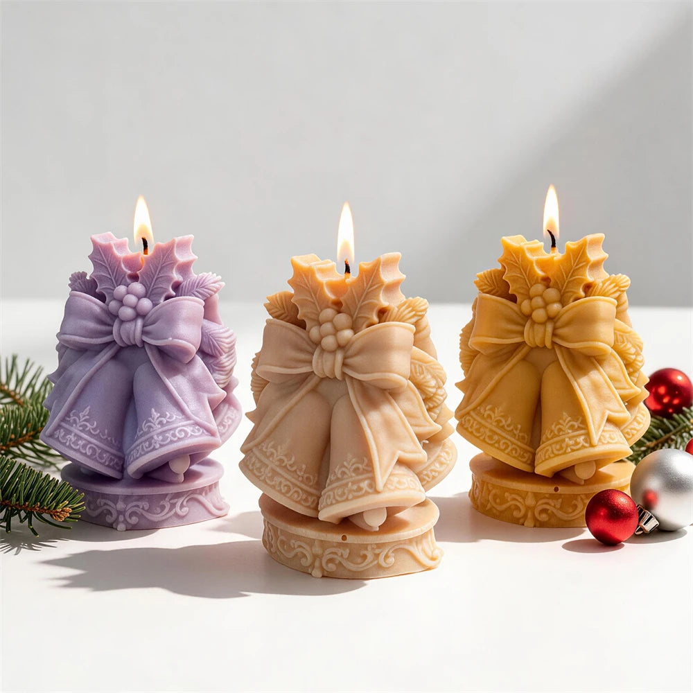 Christmas bells candles with large ribbon bows and festive holly details