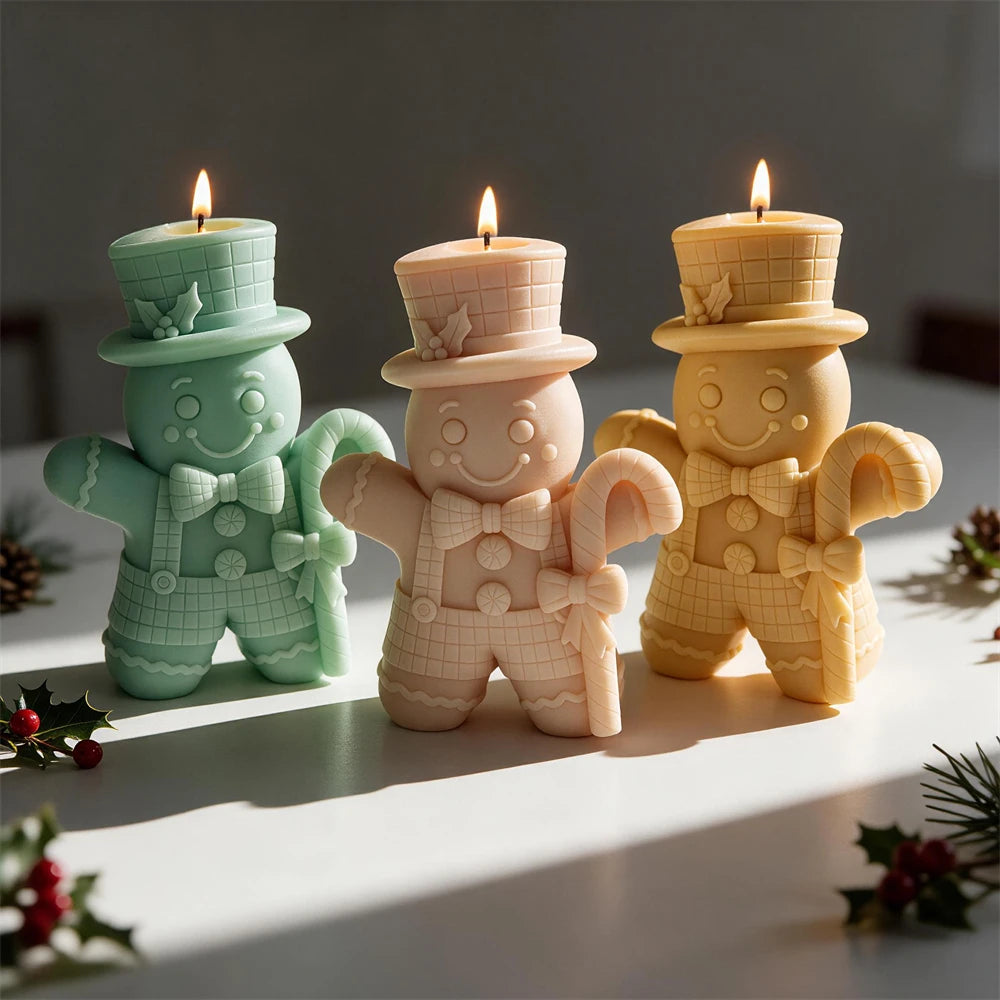 Top hat Gingerbread Man candle holding a large candy cane