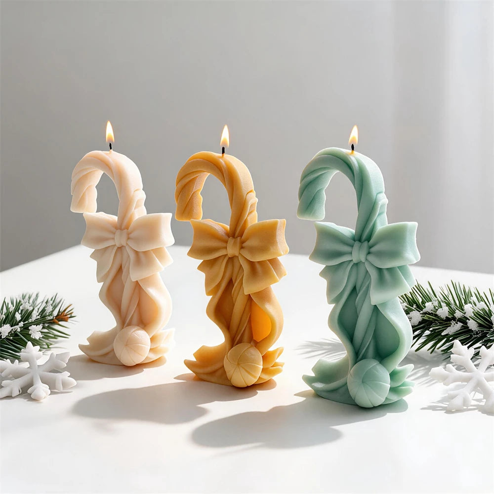 Bow-tied candy cane candles with large layered Christmas ribbon bows