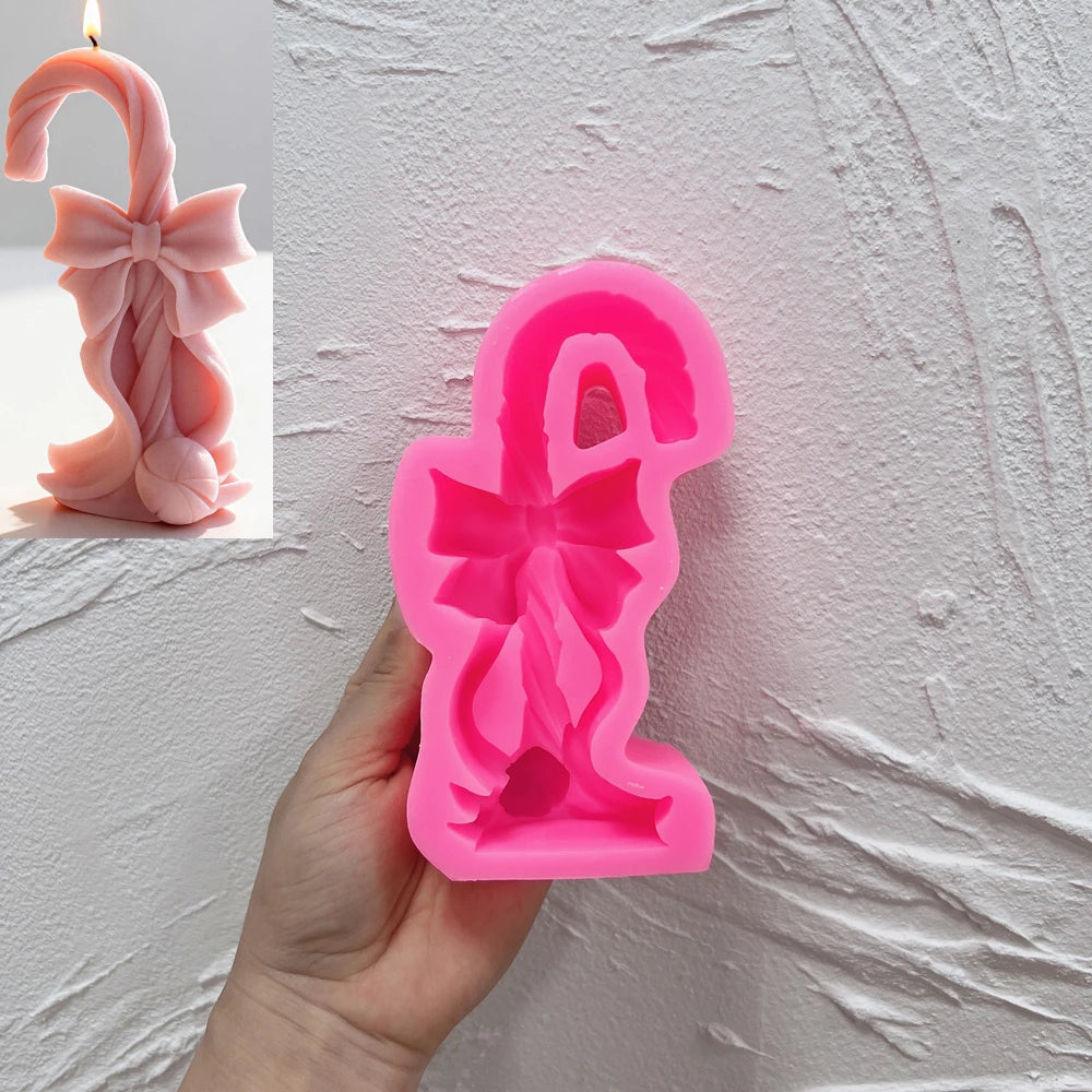 Candy cane silicone candle mold with twisted texture and flowing ribbon